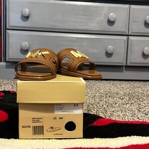 Leather MK luggage slide